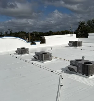 Commercial flat roof with equipment and roof penetrations.