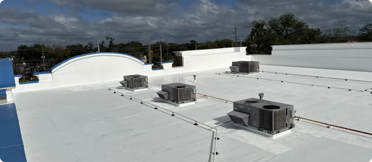Commercial flat roof with equipment and roof penetrations.
