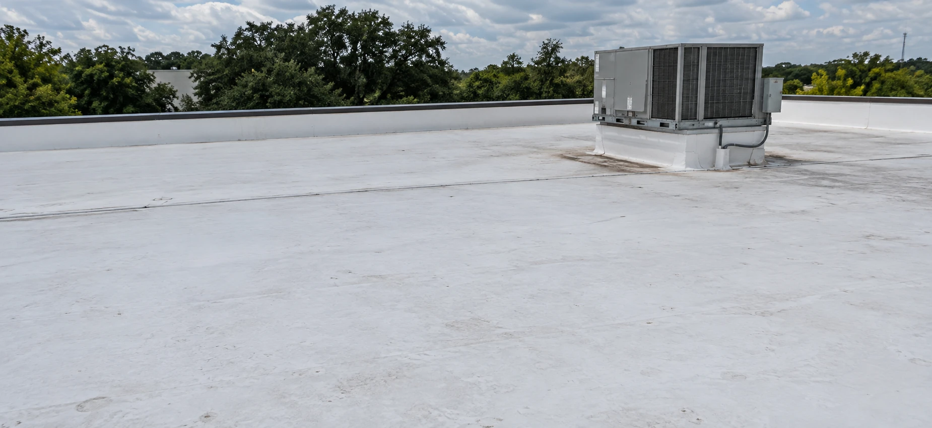 Low-slope roof with rooftop mechanical equipment.