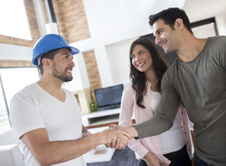 A contractor speaking with homeowners about a roofing project.