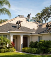 A house with a completed shingle roof and a covered front entrance.