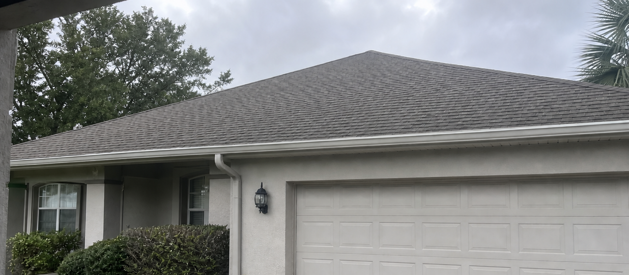 A single-story house with a shingle roof and attached garage.