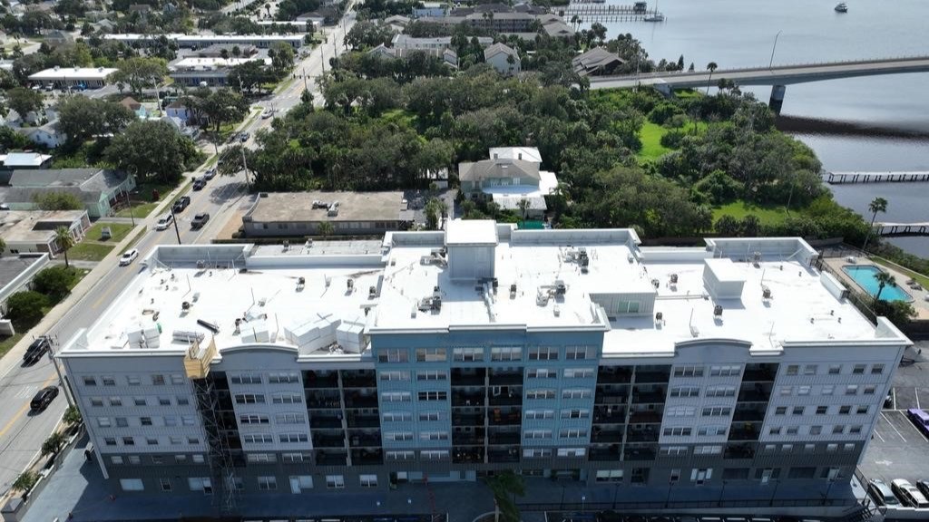 Aerial view of the completed adhered TPO roof on a commercial building in Daytona