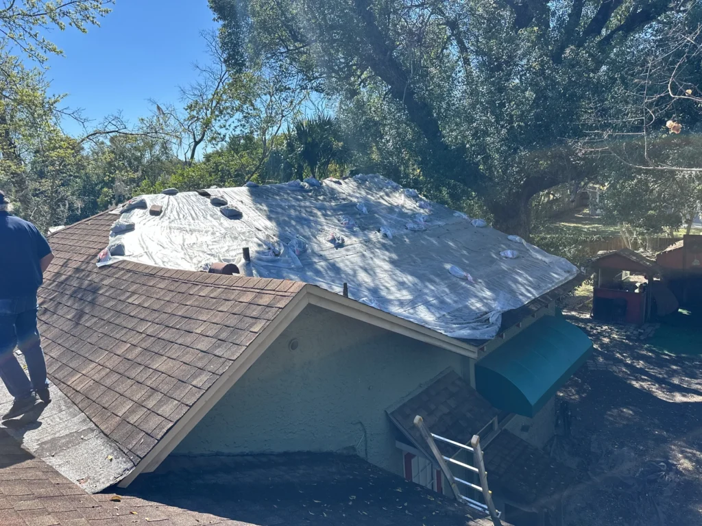 Underlayment installation on the sloped roof of the 1905 DeLand home