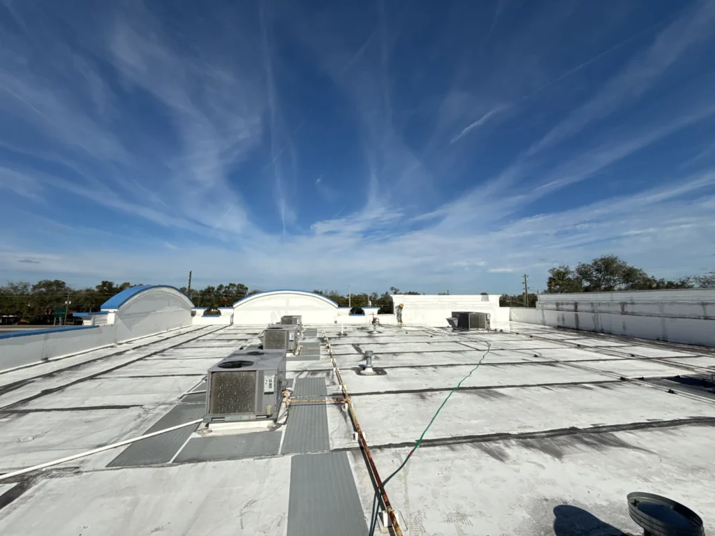 Wide view across the completed white commercial roof coating
