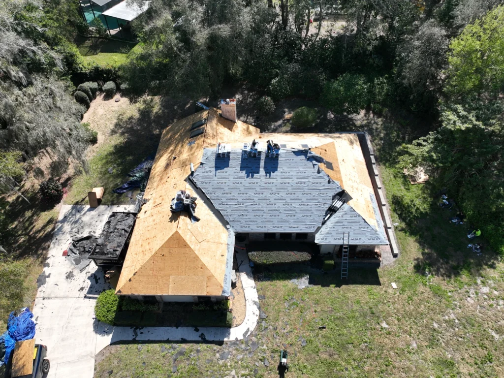 Aerial view of roof-deck and underlayment work at the Errol Estates home