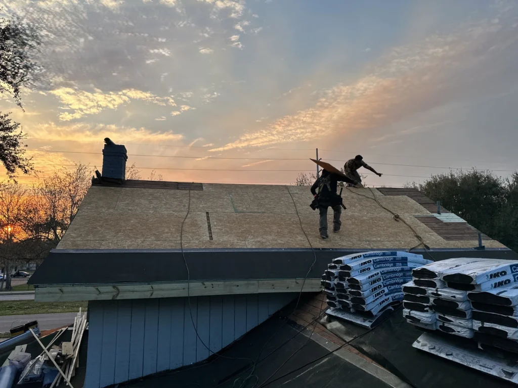 Sheathing work and staged IKO shingles during the Forest City project
