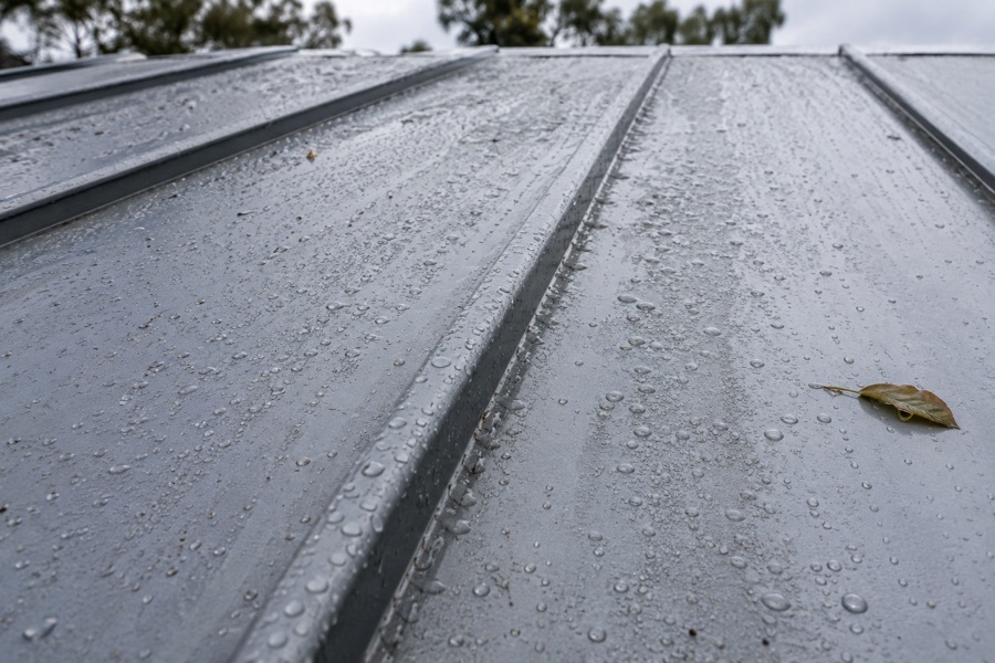Wet metal roof seam reviewed for possible leak concern