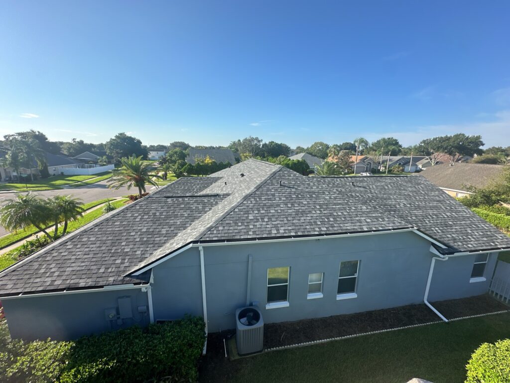 Side view of the completed shingle roof and gutters on the Ocoee home