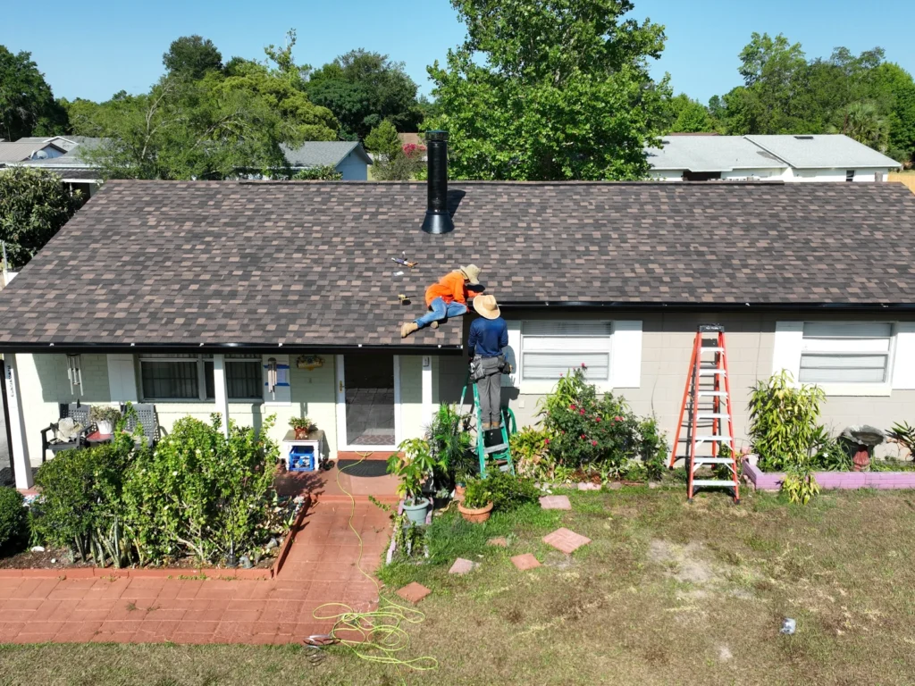 Workers installing gutters at the Pine Hills home