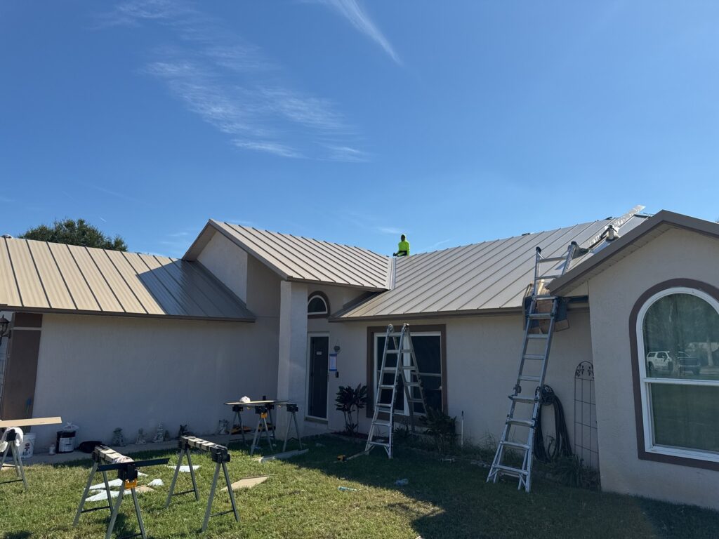Standing-seam metal panels being installed on the Rock Springs Ridge home