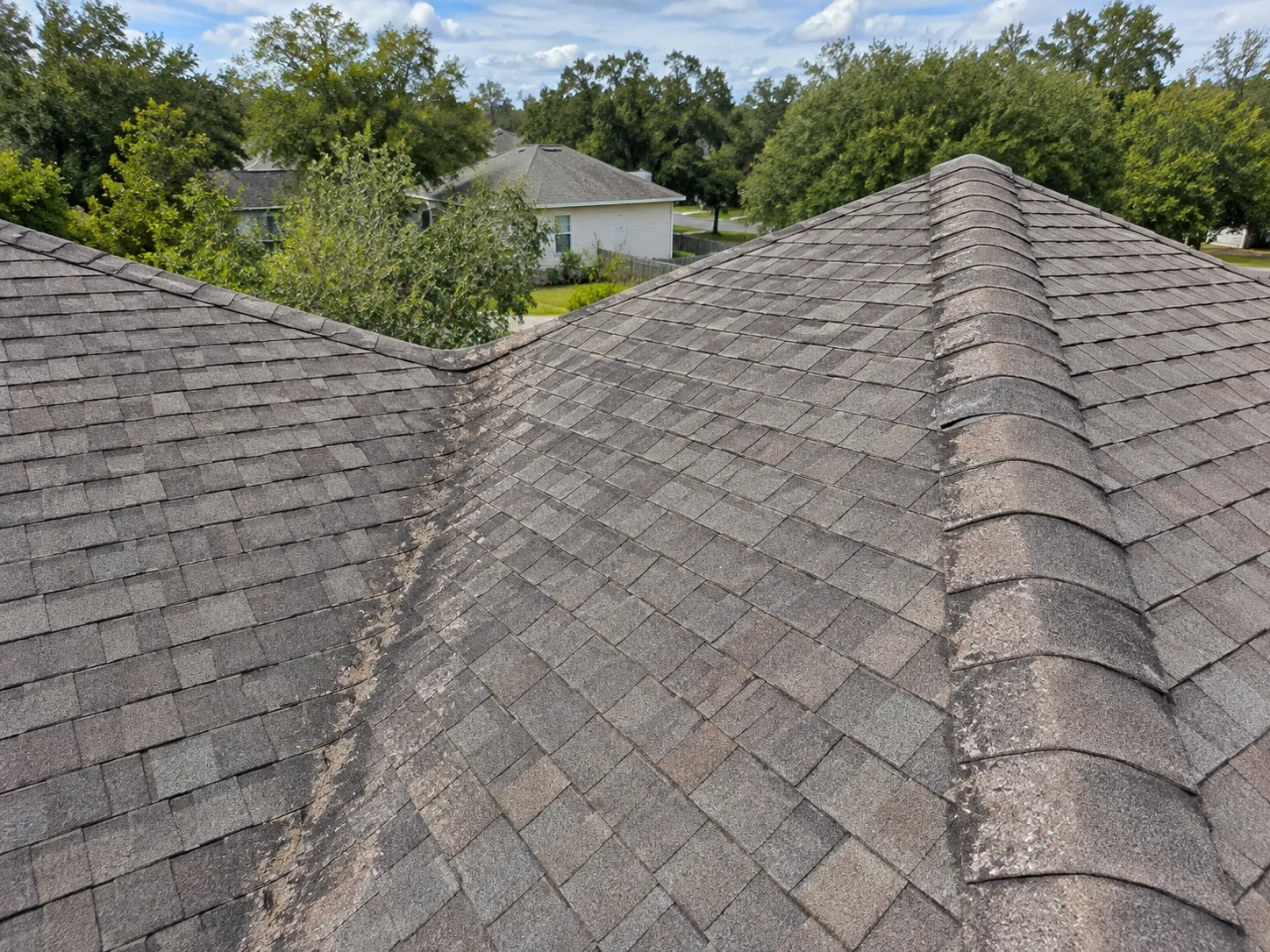 Wear along a shingle roof valley and ridge.