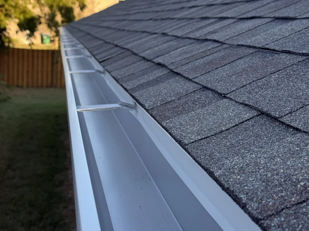 Close view of the shingles and seamless gutter at the Tuskawilla property