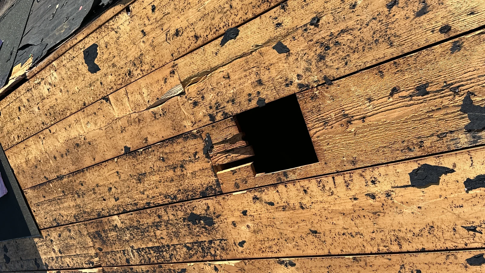 Exposed opening in the roof deck during a Winter Park roof replacement