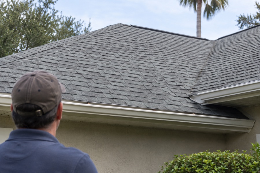 Inspector reviewing an asphalt shingle roof