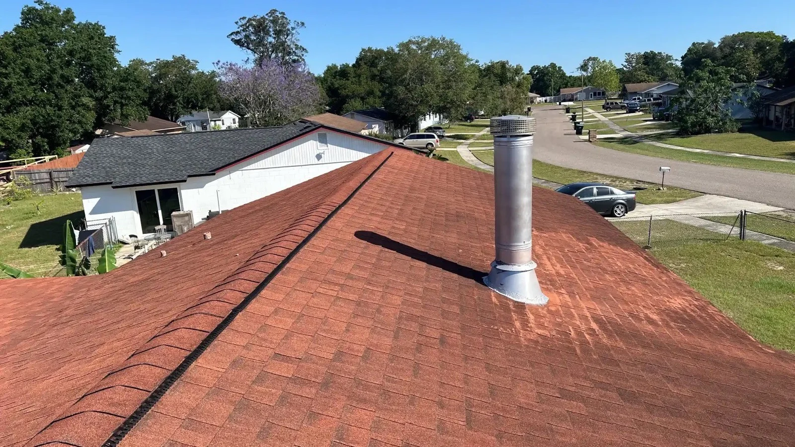 Close view of a shingle roof and roof vent on a Florida home