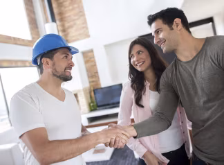 A contractor speaking with homeowners about a roofing project.